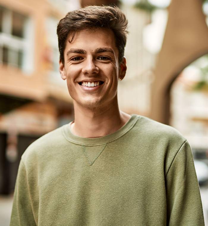 Man in green shirt smiling