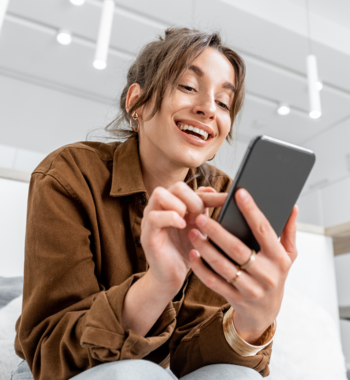 Smiling woman looking at her phone